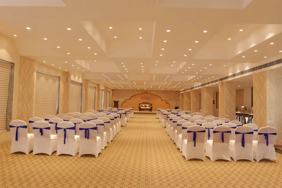 Banquet hall set with rows of chairs facing the stage