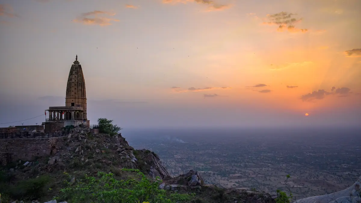 Harshnath temple spire on the Aravalli hilltop at sunset, above the Shekhawati plains