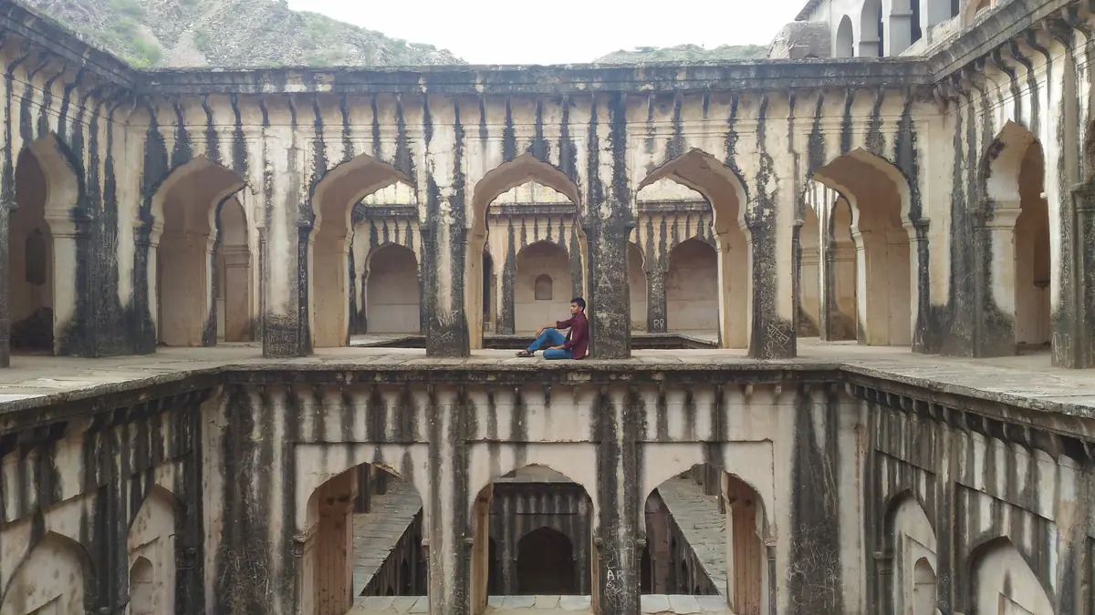 Arched stone galleries of the historic stepwell at Lohargal
