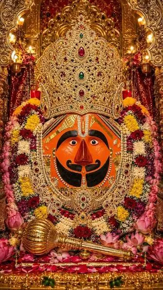 Shri Salasar Balaji in a jewelled crown, framed by flower garlands