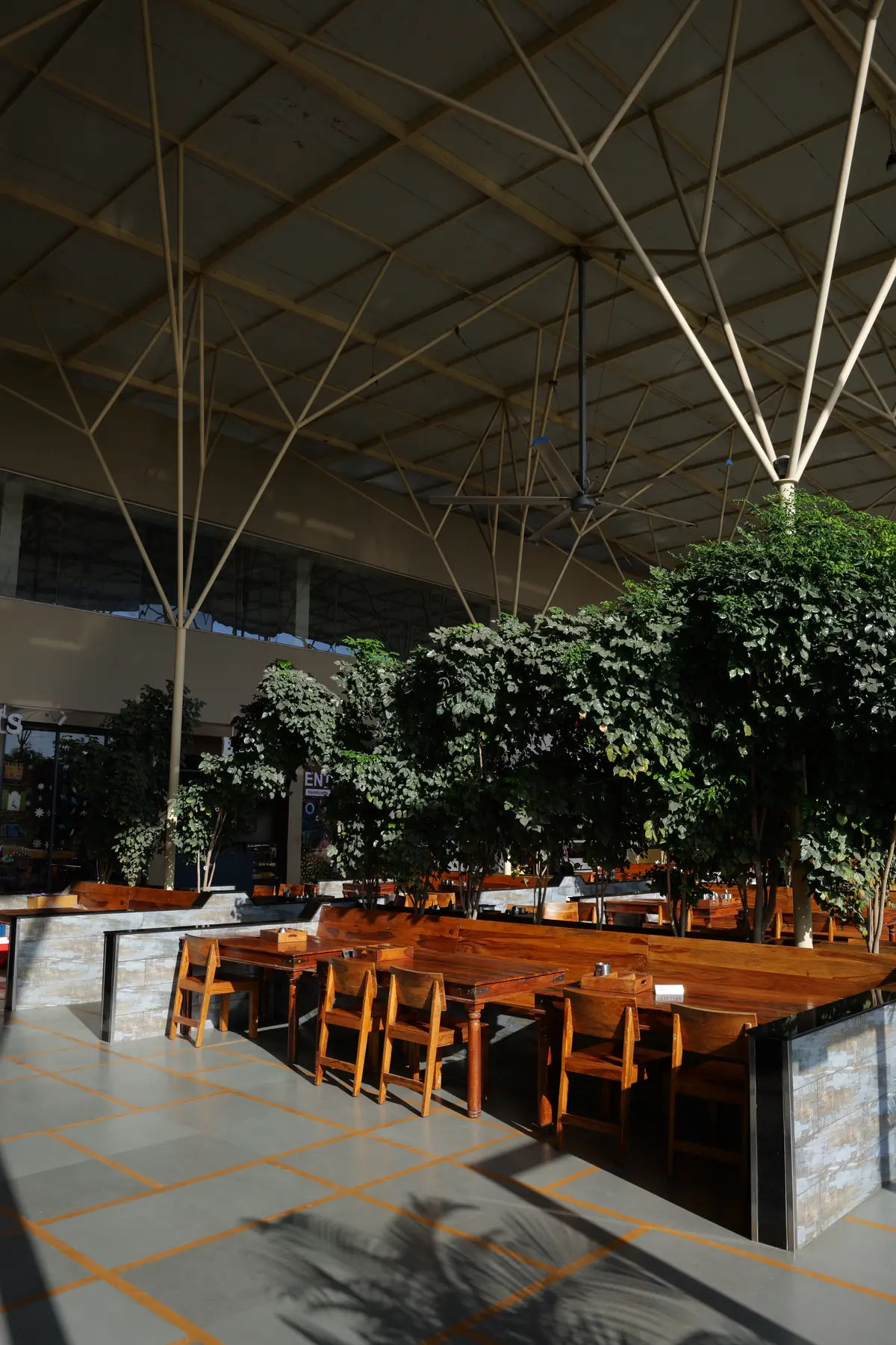 Dining tables shaded by trees