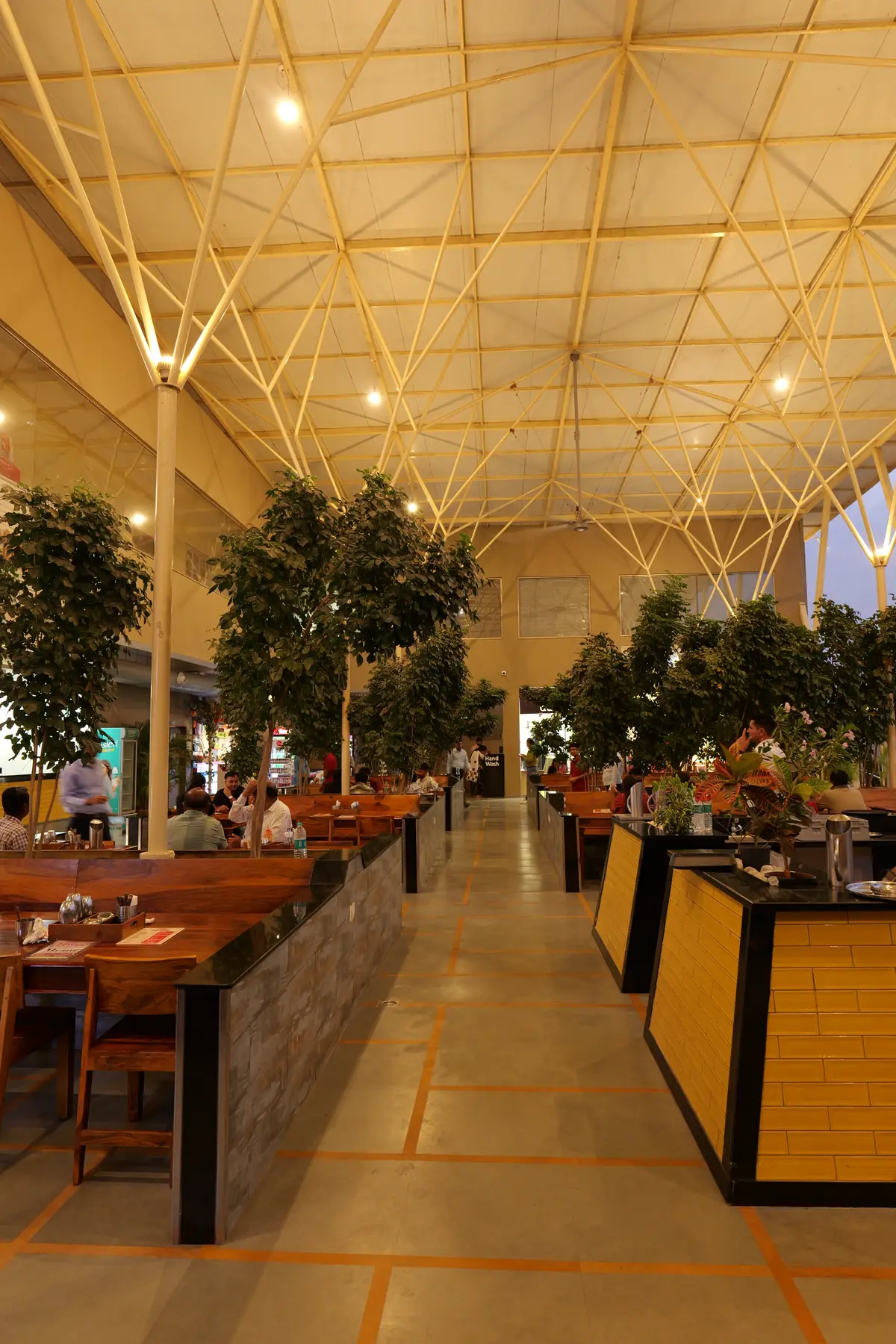Food court seating among indoor trees