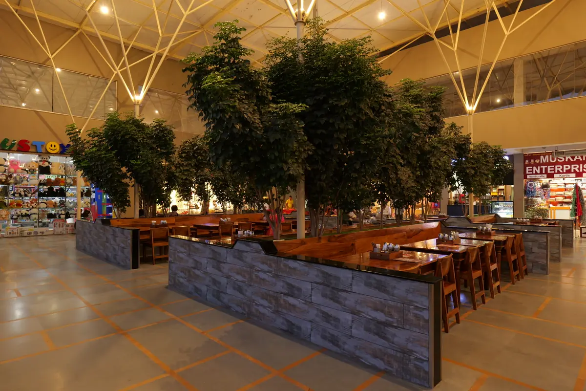Wooden dining tables among the trees
