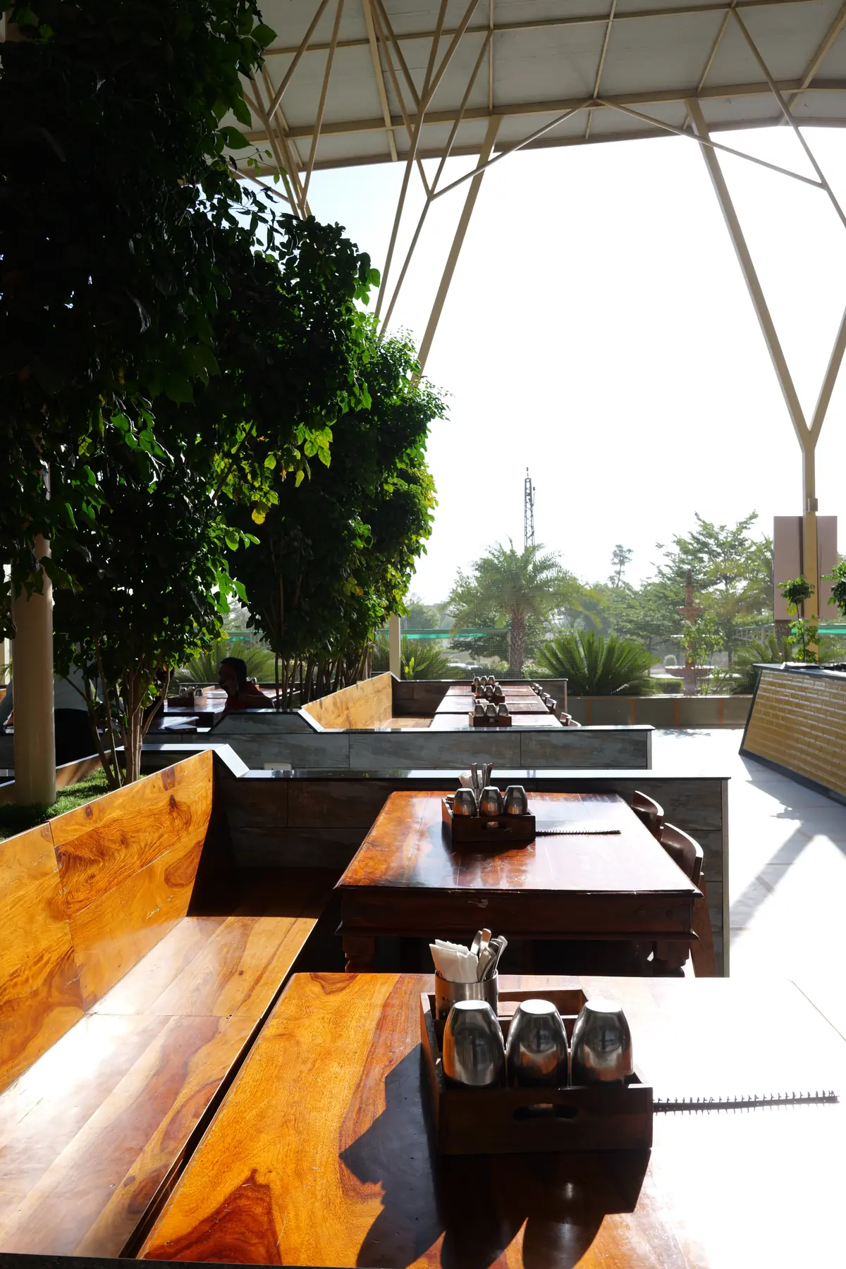 Garden-facing tables beneath the trees
