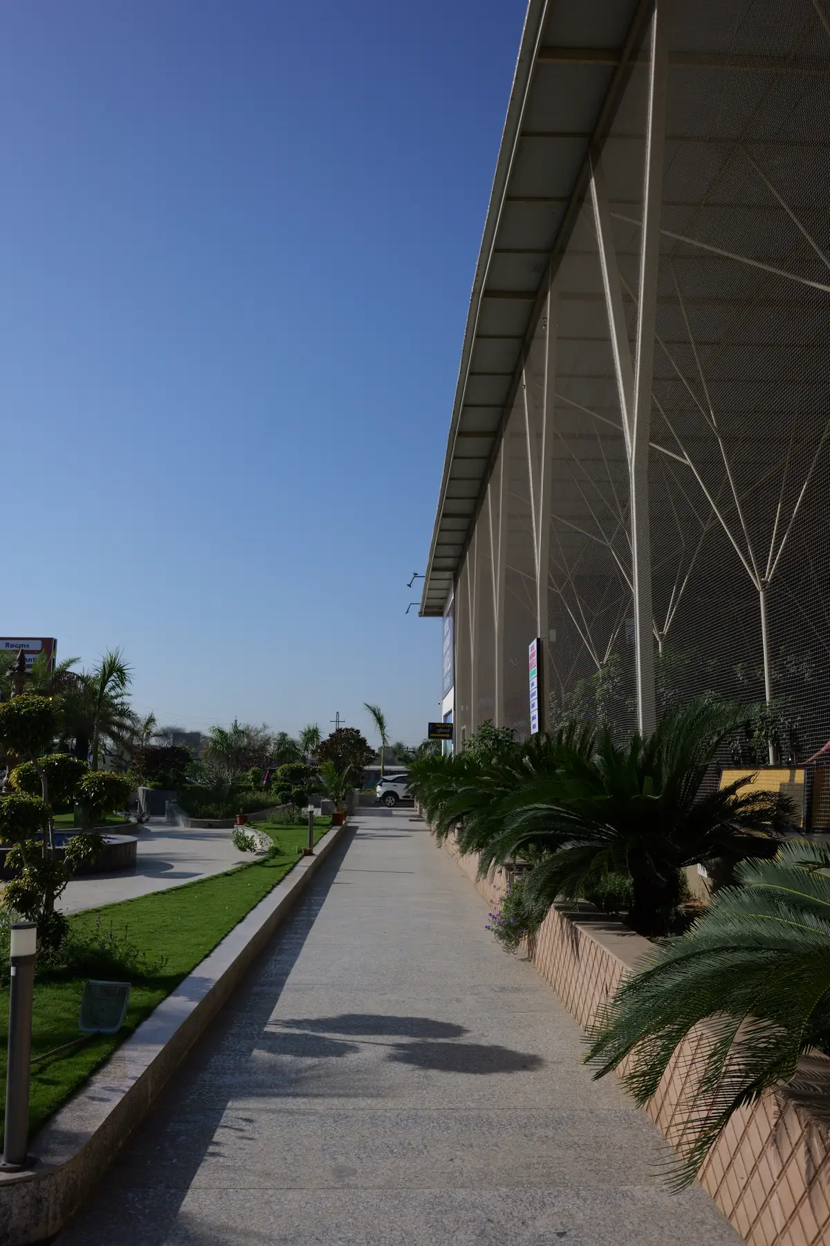Landscaped walkway along the building on a clear morning