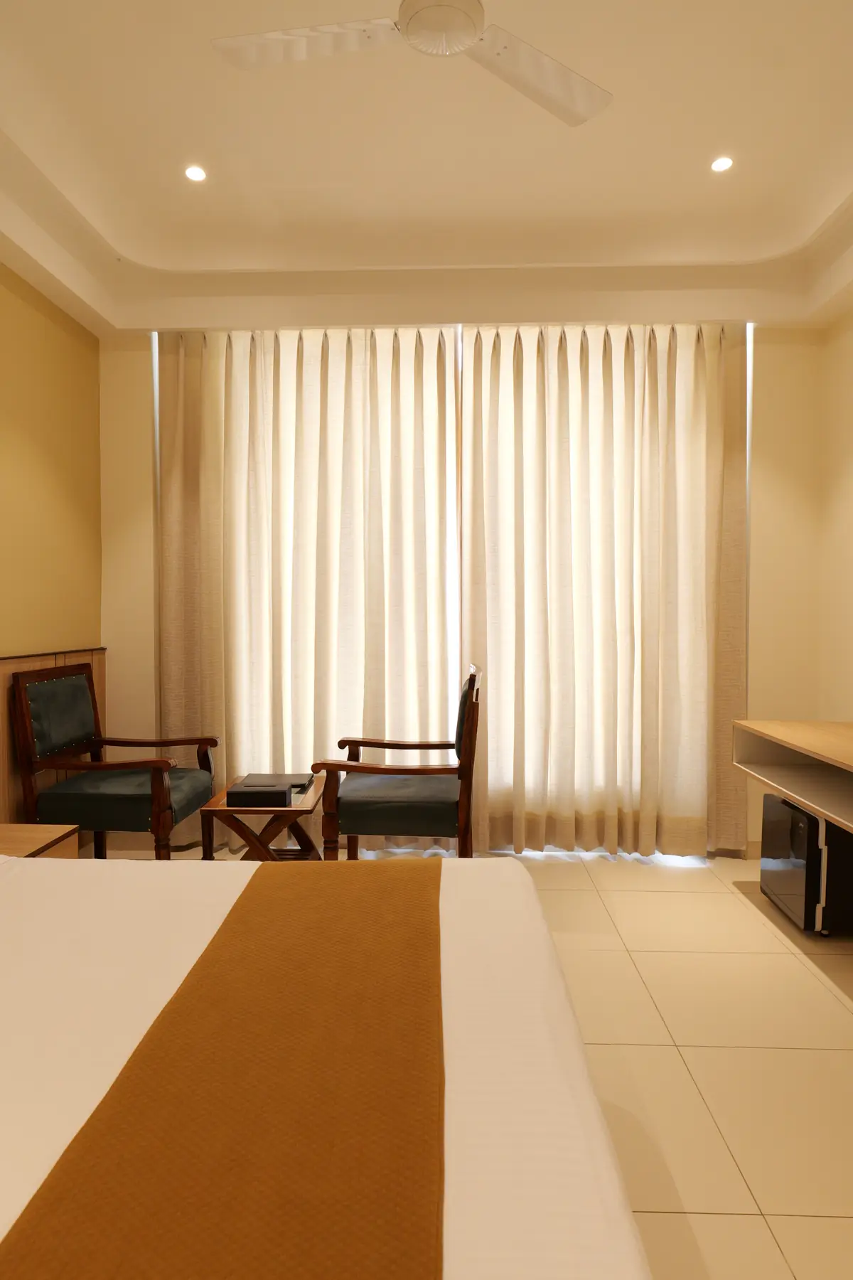 Armchairs by the window in a guest room